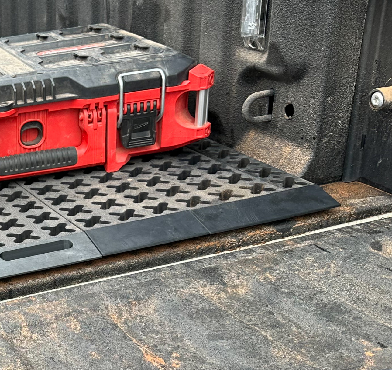 Tmat ramp set and handle in a dirty pickup with a tool box.