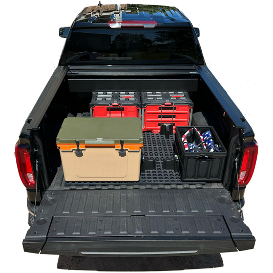 GMC short bed truck with Tmat securing boxes and a cooler