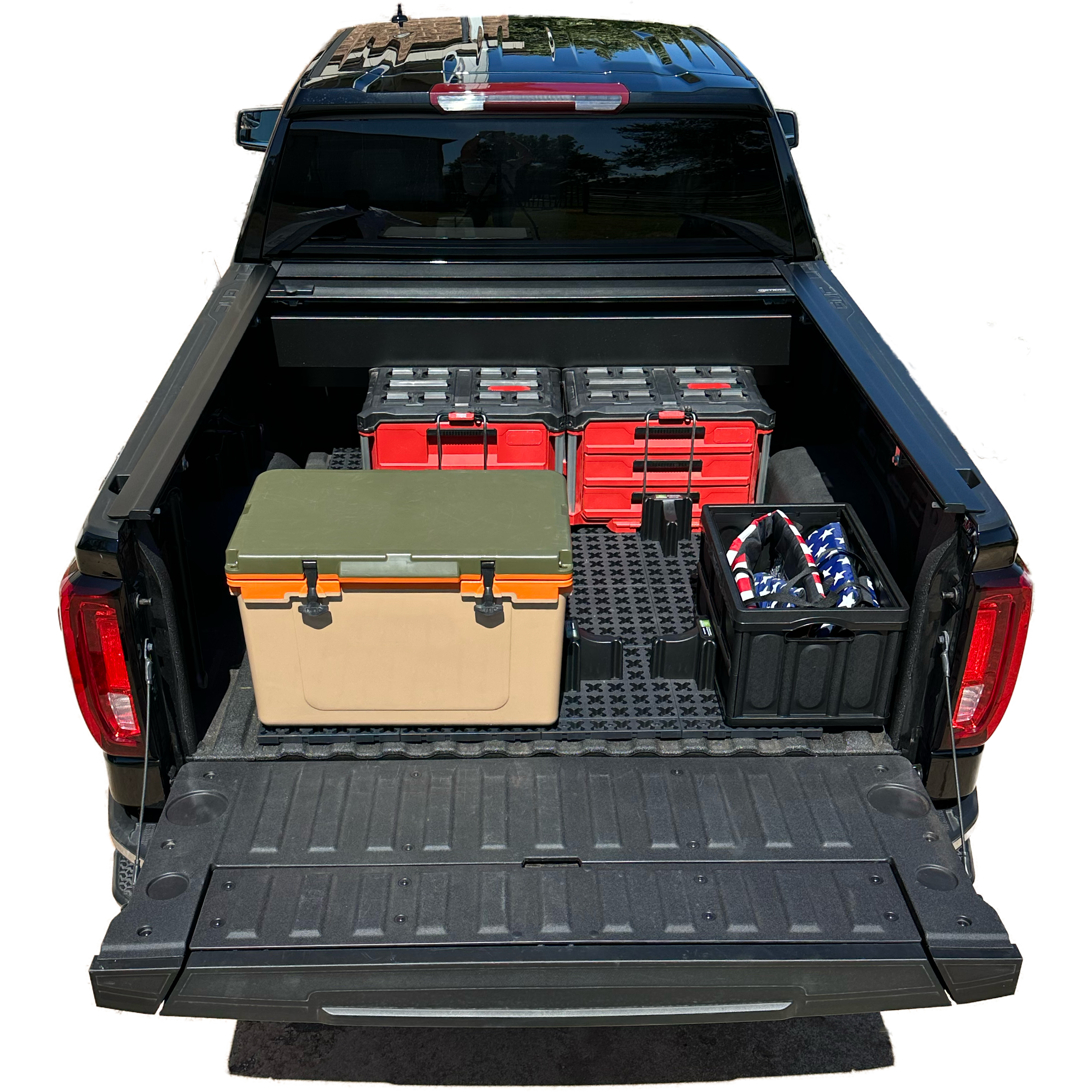 GMC short bed truck with Tmat securing boxes and a cooler