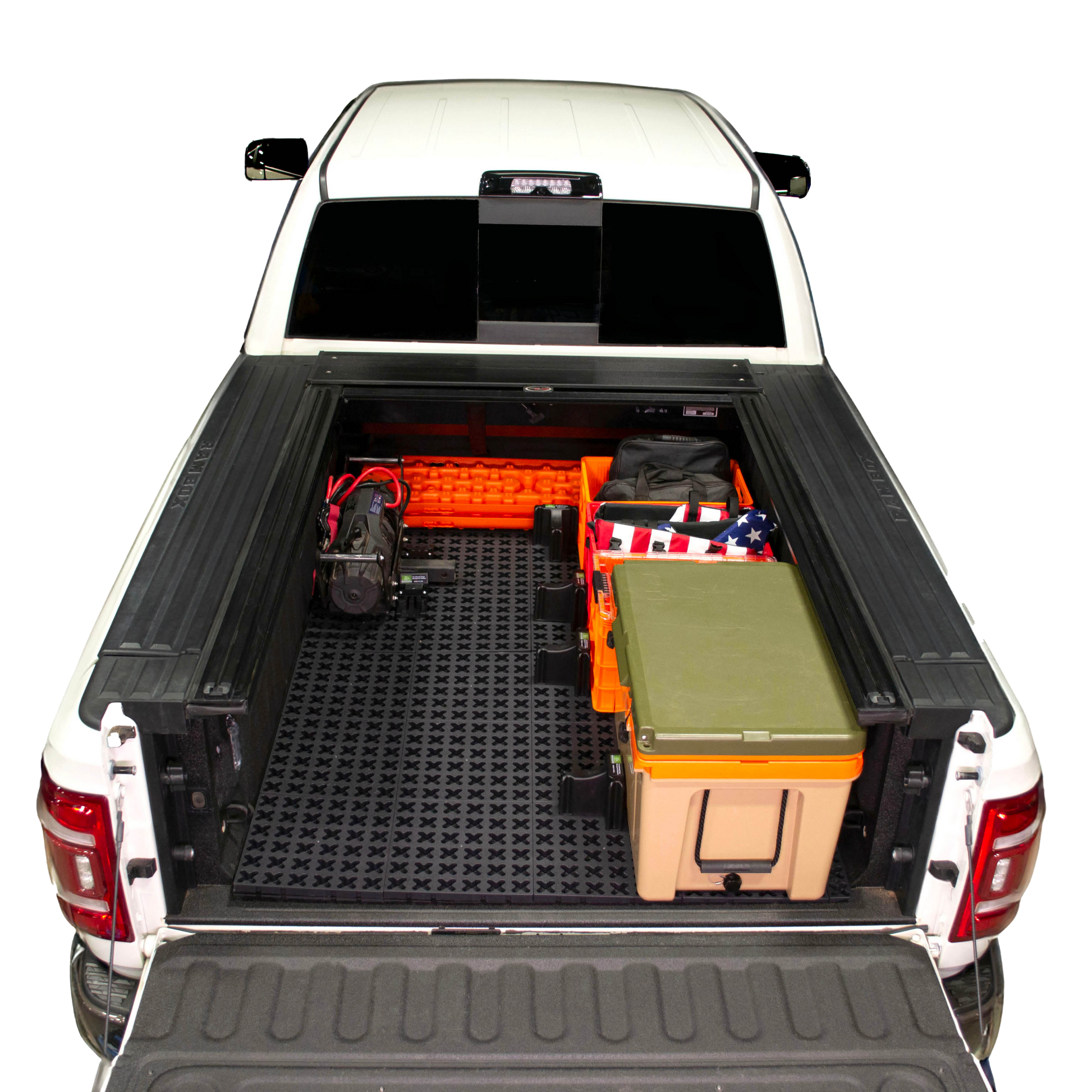 Tmat installed in a Ram 3500 securing a winch, recovery boards, Sidio crates, and a Rtic cooler. 