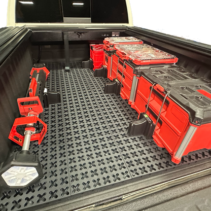 Tmat grid cargo system securing Milwaukee Packout tool boxes and a Milwaukee shop light.