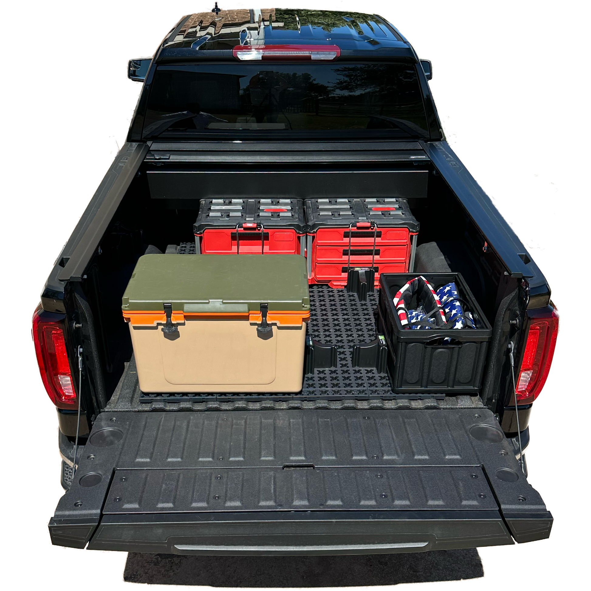 GMC short bed truck with Tmat securing red tool boxes and a brown cooler