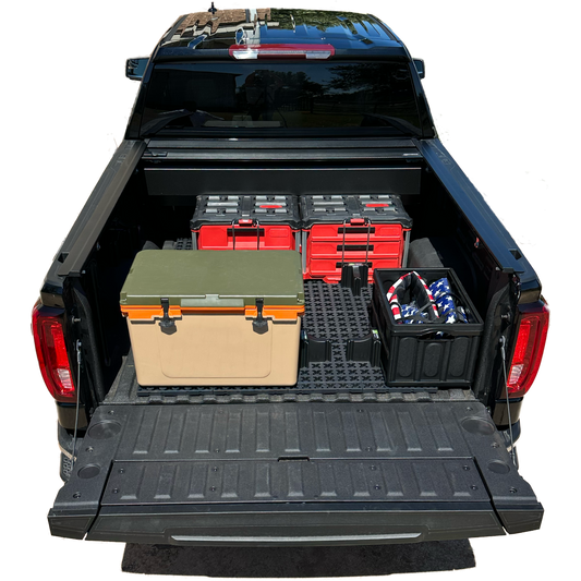 GMC short bed truck with Tmat securing red tool boxes and a brown cooler