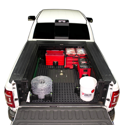 Tmat bed mat around a gooseneck hitch with tool boxes, a bucket, t-posts, and barb wire.