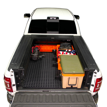 Tmat installed in a Ram 3500 securing a winch, recovery boards, Sidio crates, and a Rtic cooler. 