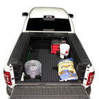 Tmat Cargo System in a Ram pickup bed with a bucket, t-posts, barb wire, a bag of cattle feed, and Milwaukee Packout toolbox.